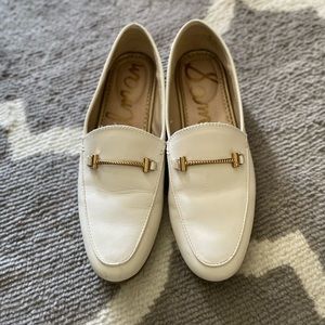 White Sam Edelman loafers with gold buckle detail